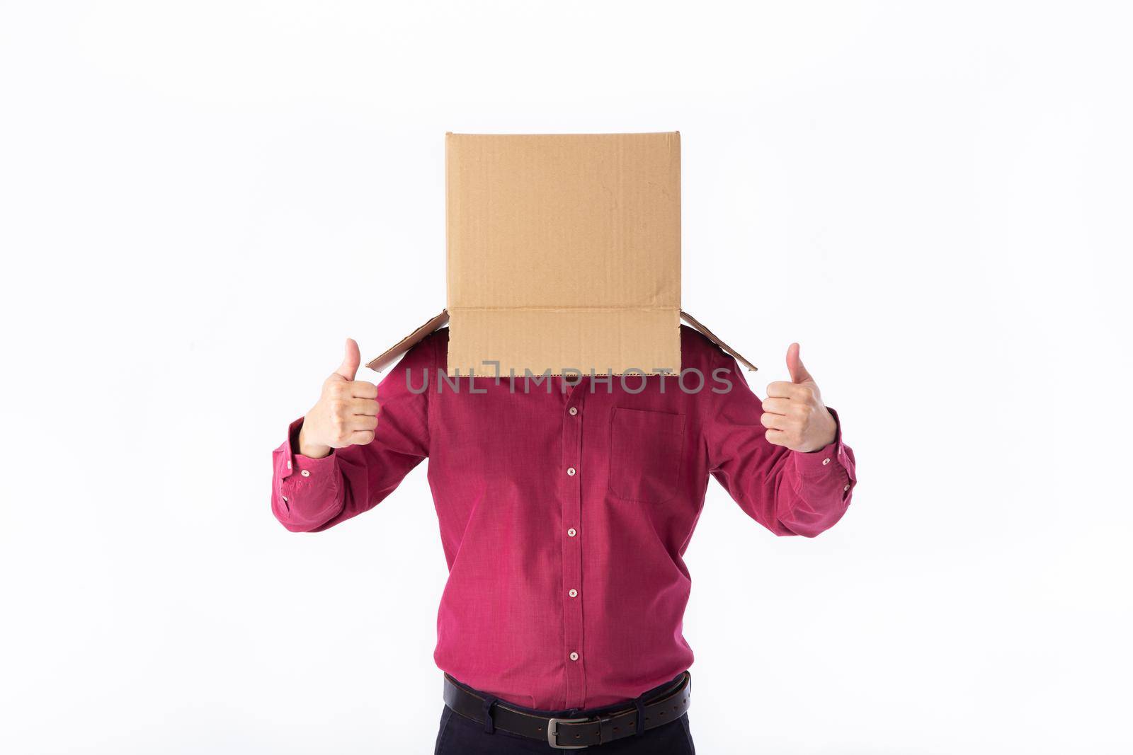 man in a red shirt with a cardboard box on his head makes a gesture with his hands isolated on white background
