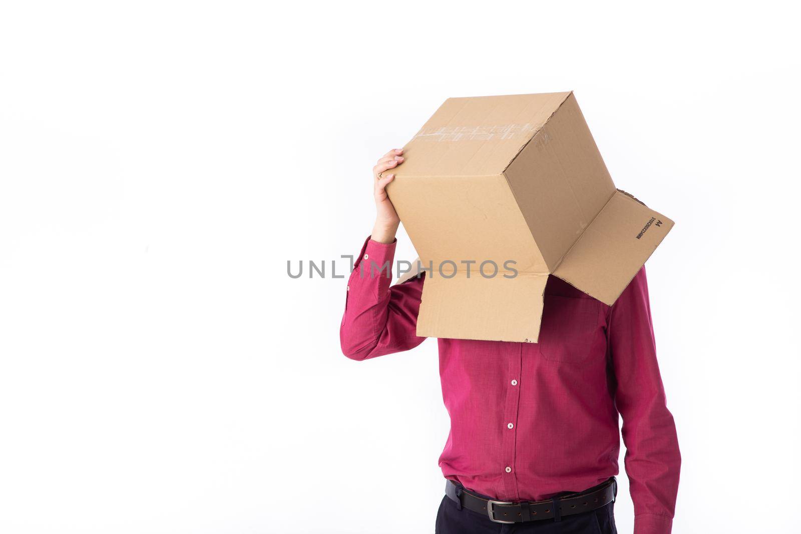 man in a red shirt with a cardboard box on his head makes a gesture with his hands by tehcheesiong