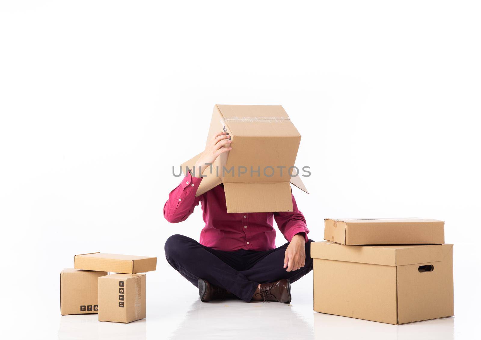 man cover his head with cardboard and confused on courier parcels. by tehcheesiong