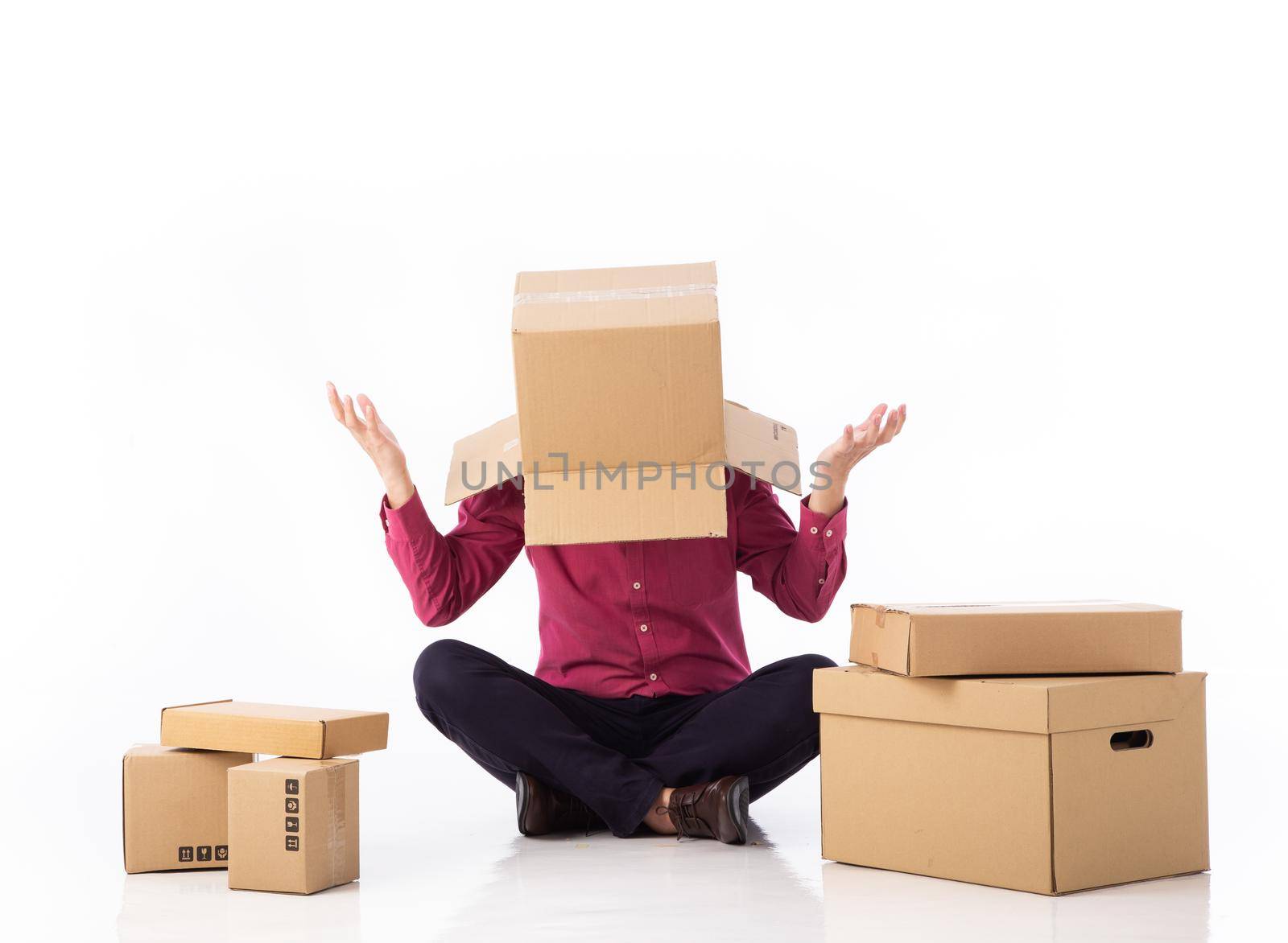 man cover his head with cardboard and confused on courier parcels. by tehcheesiong