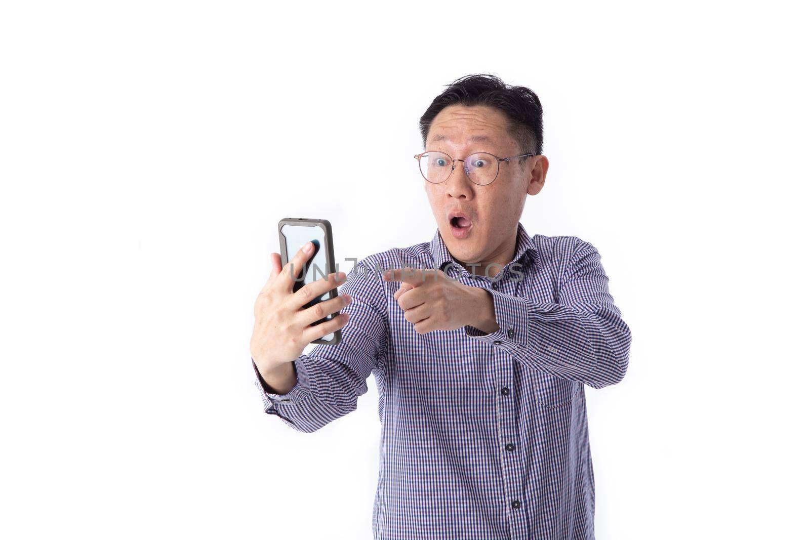 Surprised face of Asian man shocked what he see in the smartphone on isolated white background.