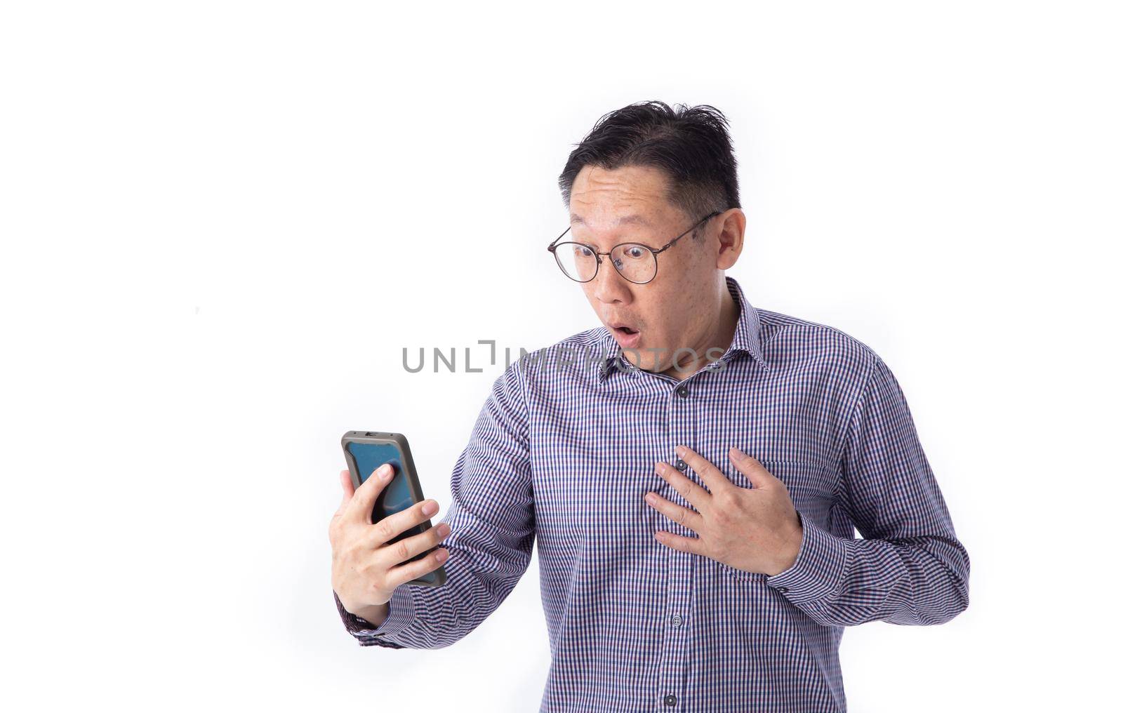 Surprised face of Asian man shocked what he see in the smartphone on isolated white background.