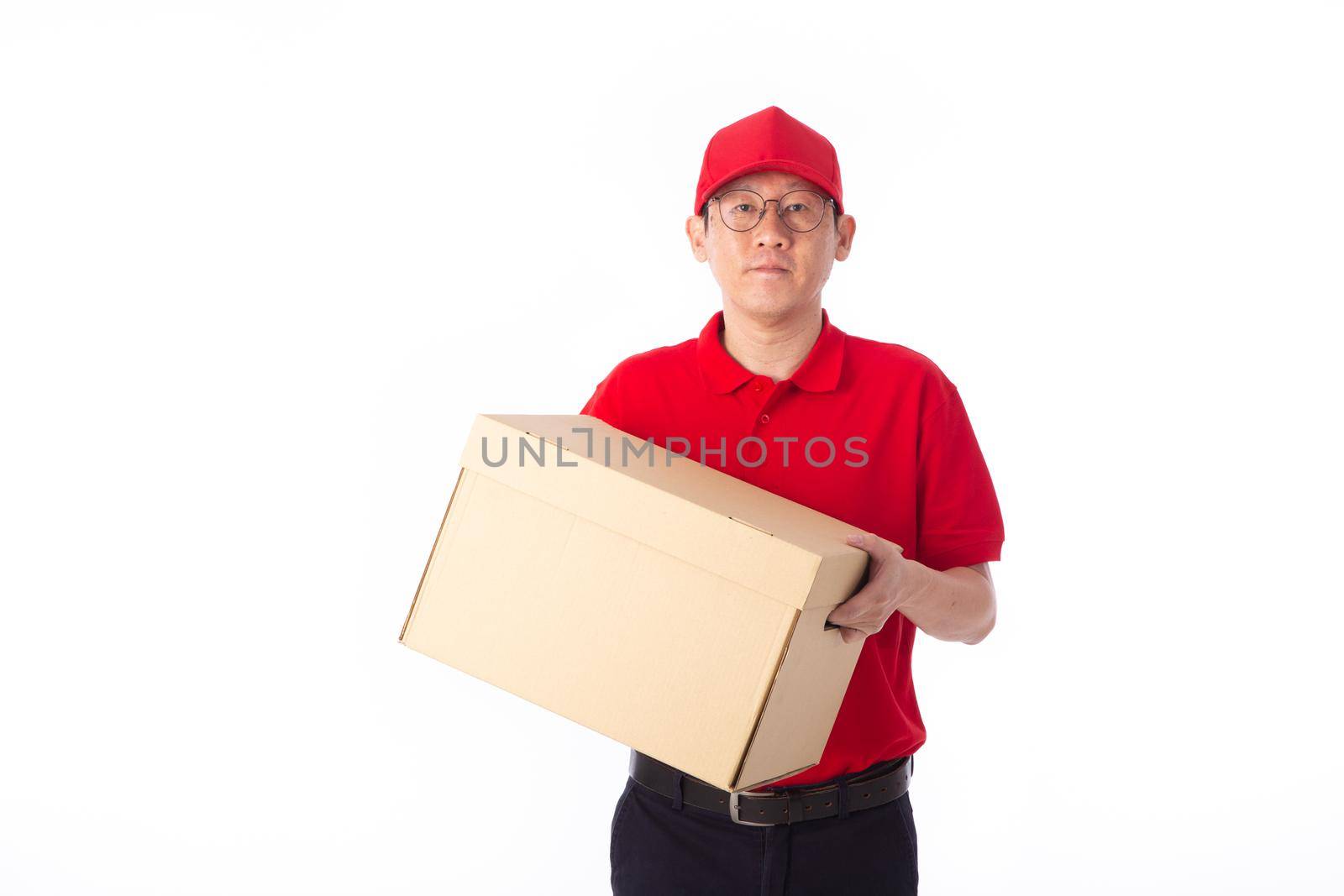 young Asian delivery man in red uniform, carry cardboard box in hands isolated on white background. Delivery Concept