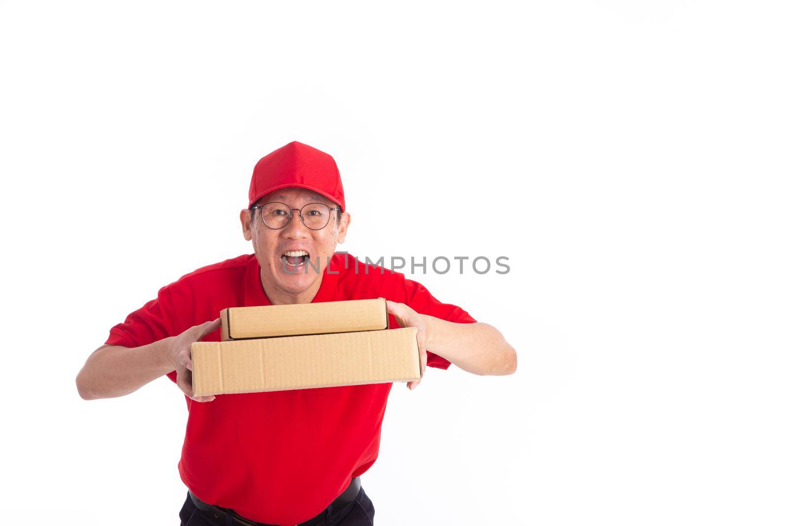 young Asian delivery man in red uniform, carry cardboard box in hands isolated on white background. Delivery Concept