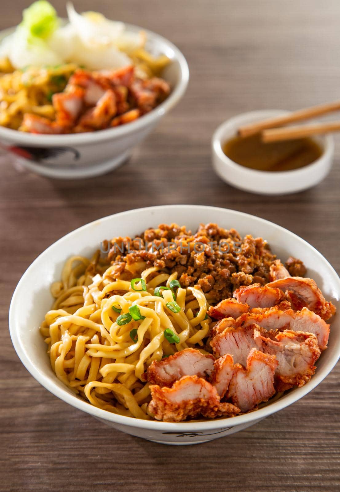 A Kolo Mee is a Sarawak Malaysian dish of dry noodles tossed in a savoury pork and shallot mixture, topped off with fragrant fried onions.