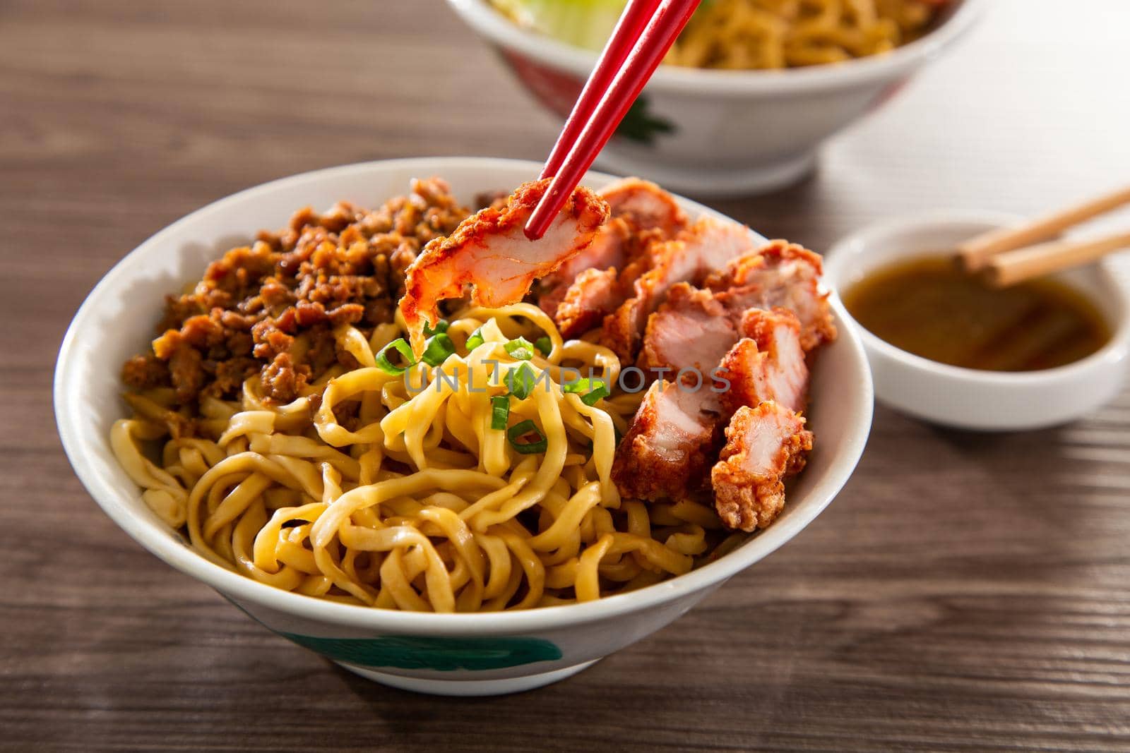A Kolo Mee is a Sarawak Malaysian dish of dry noodles tossed in a savoury pork and shallot mixture, topped off with fragrant fried onions.