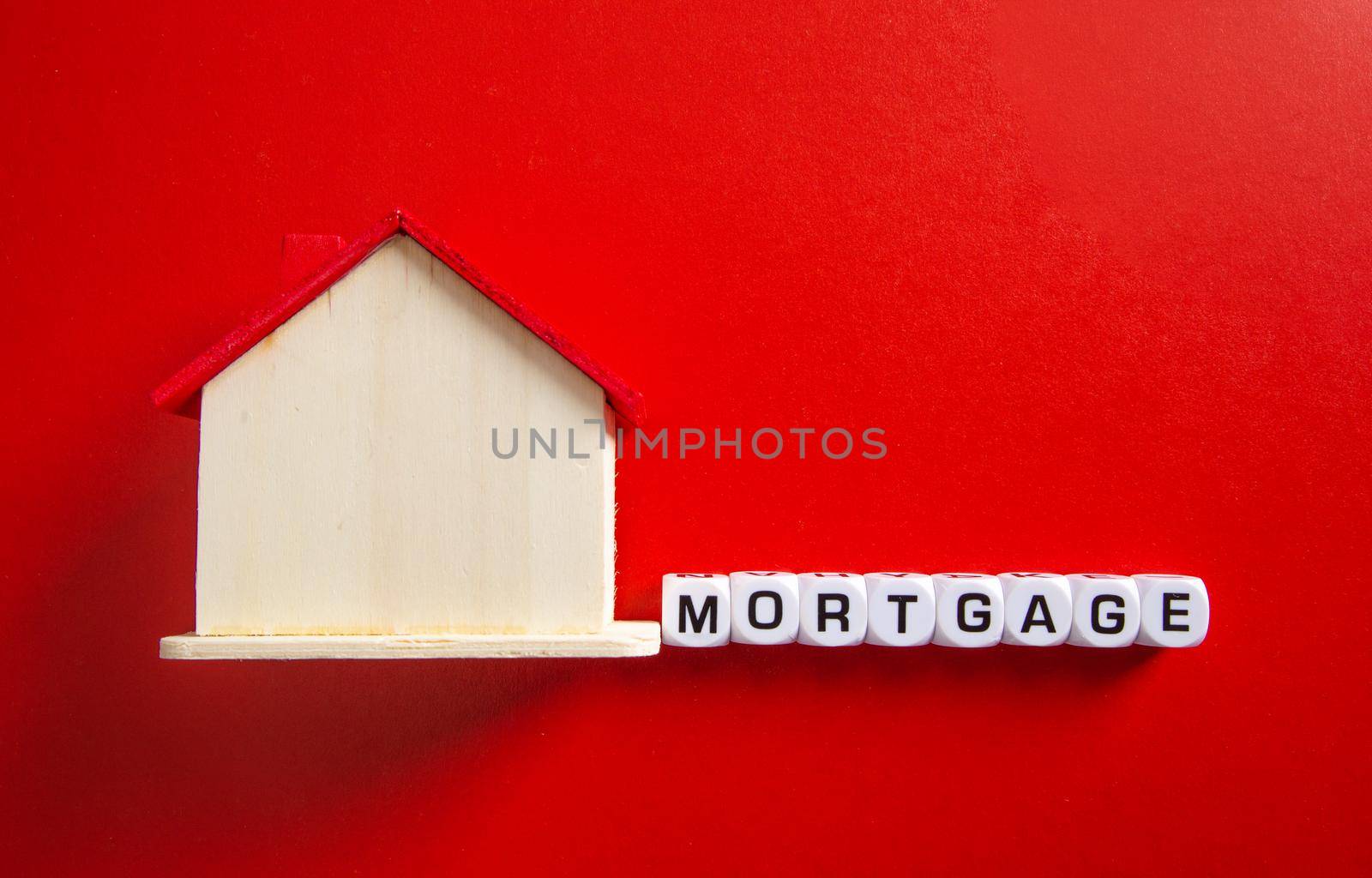 Property investment and house mortgage financial concept, Wooden house with mortgage word