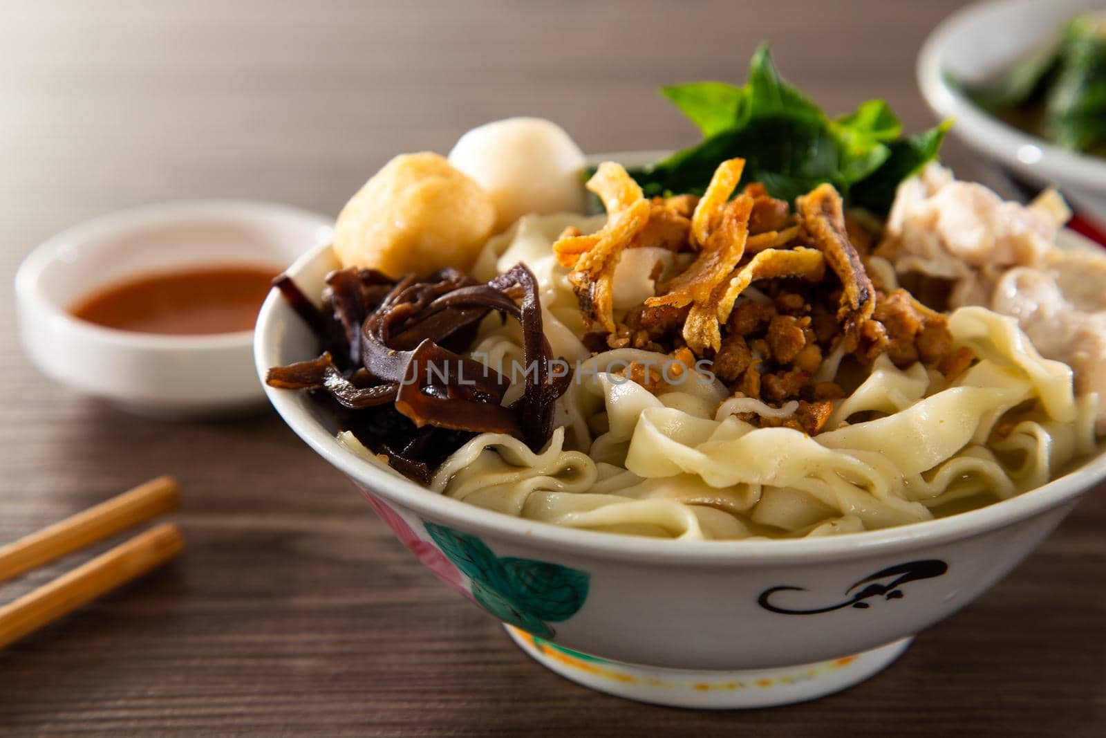 Pan Mee is made with a simple flour-based dough, with anchovy broth, and topped with crispy fried anchovies, ground pork, shiitake mushrooms, and some vegetables.