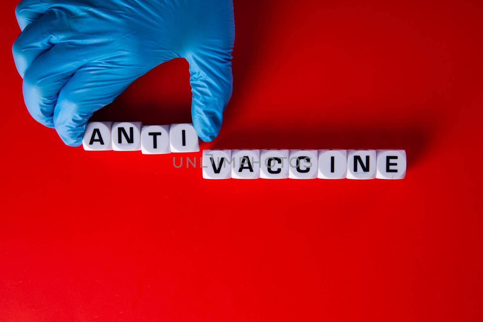 Pro-vaccine symbol. Doctor hand  with words 'Anti-vaccine'. Medical covid-19 anti-vaccine concept.