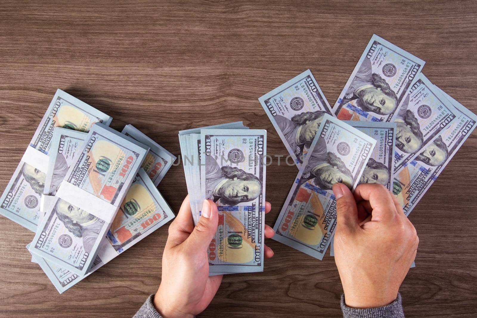 woman counting American money or 100 USD dollars note at table,finances, accounting and business concept