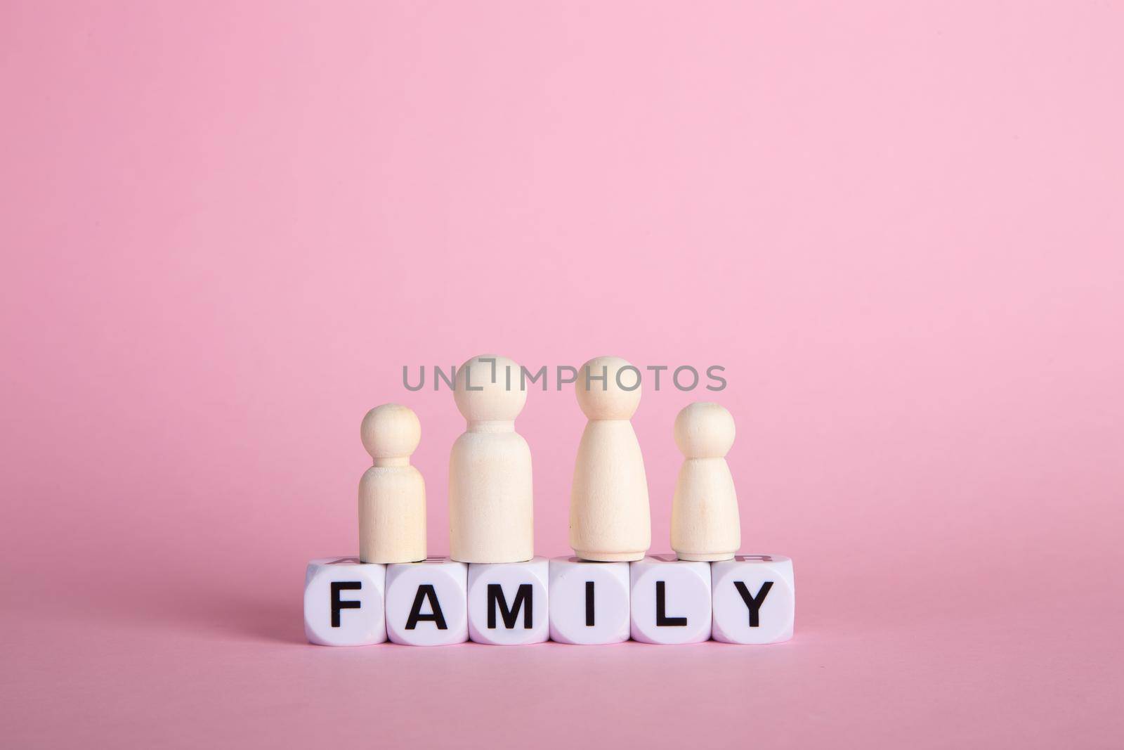 Family made of wooden peg. Family insurance protection onceptual.