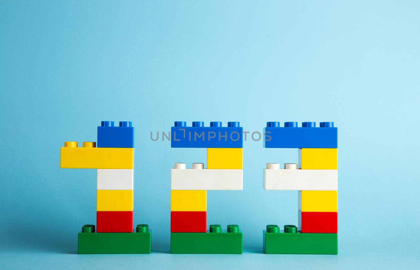 Plastic building blocks on blue background