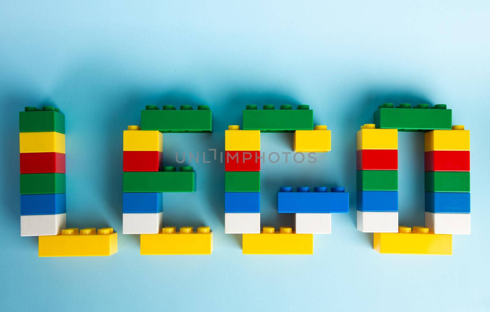 Plastic building blocks on blue background