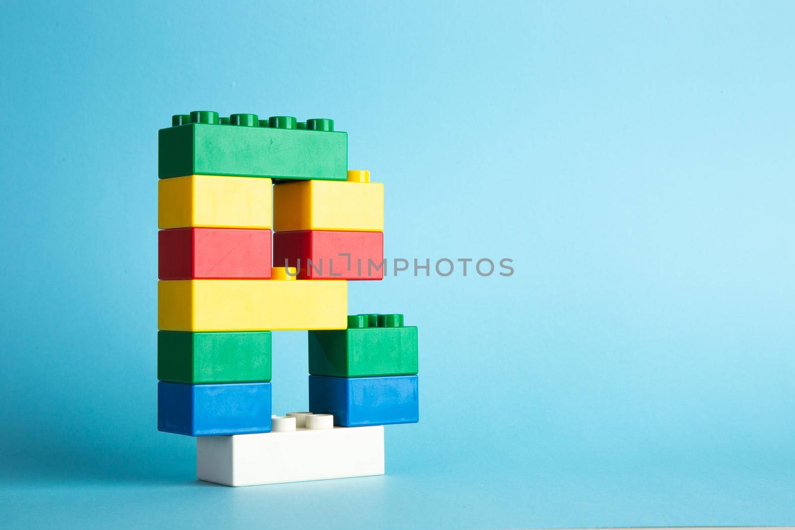 Plastic building blocks on blue background