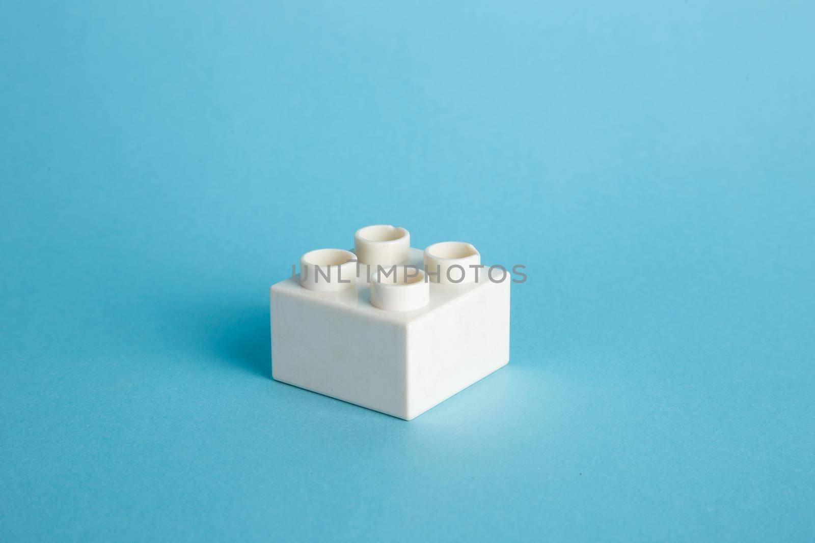 Plastic building blocks on blue background