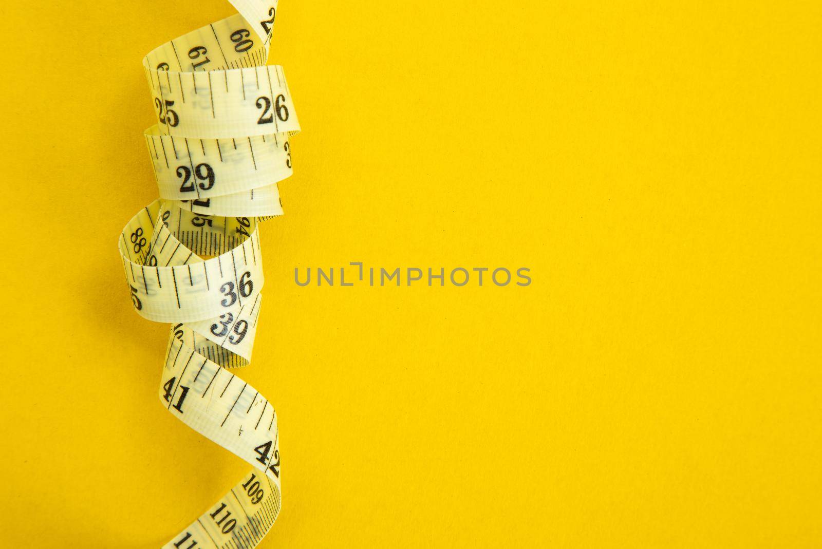 Proper nutrition for slimming. Fork with wound measuring tape. Diet Concept