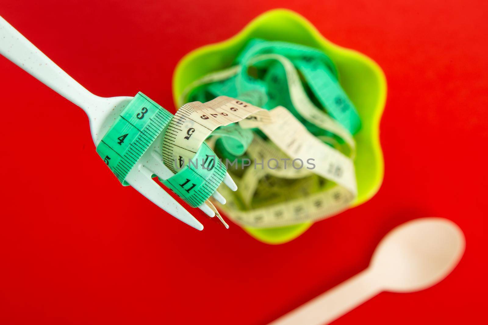 Diet for weight loss concept. Proper nutrition. Empty plate with fork and measuring tape.