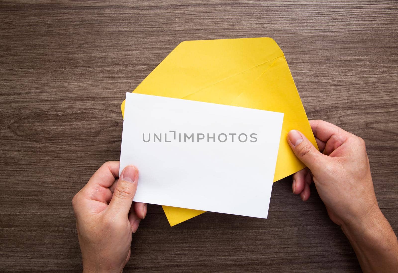 Colorful paper envelopes on wodden background - top view