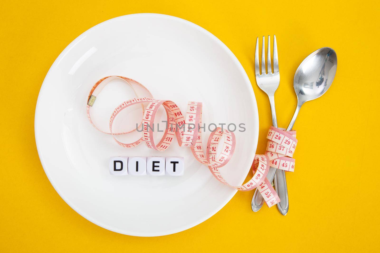 Measuring tape on a fork and knife - dieting concept
