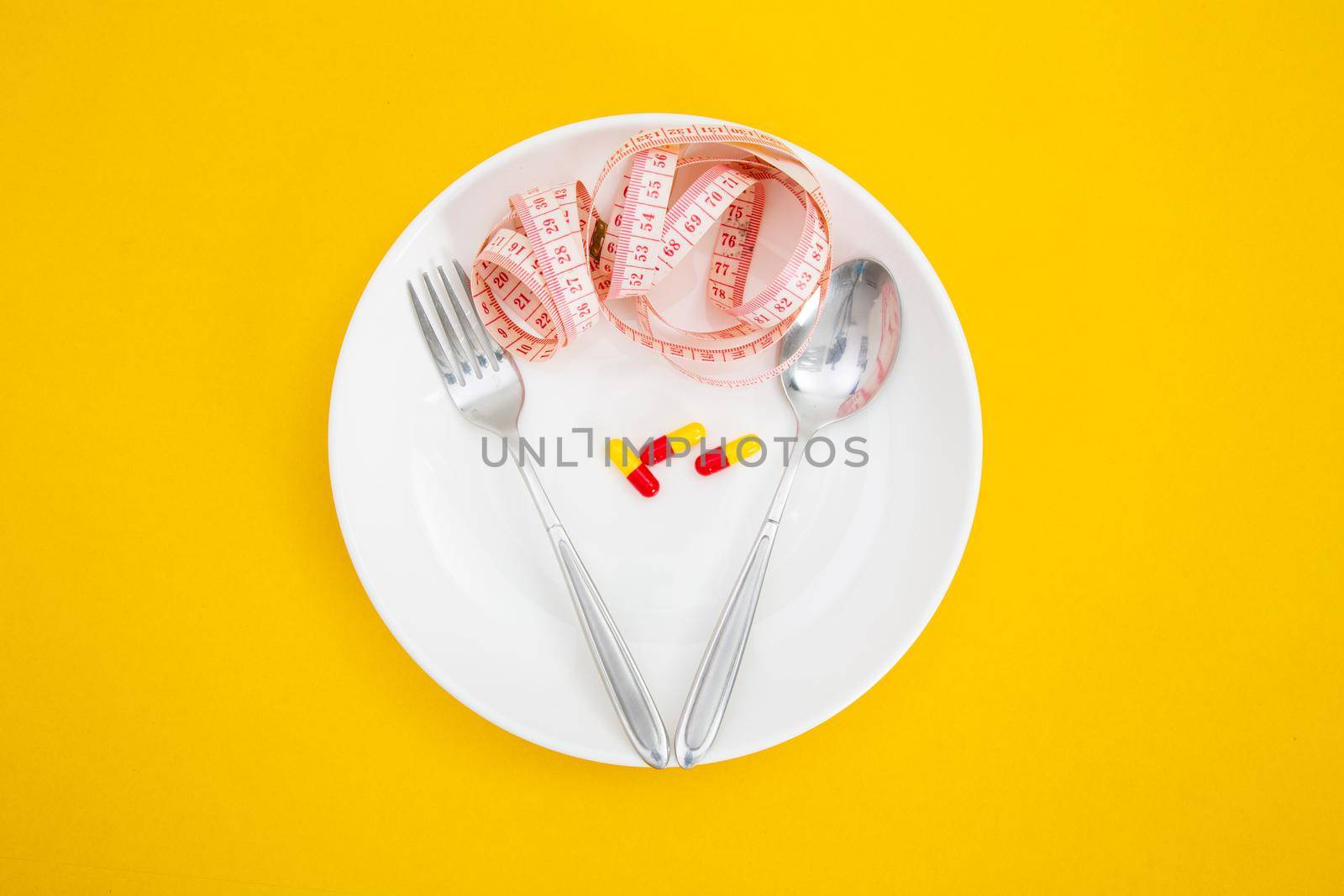 Measuring tape on a fork and knife - dieting concept
