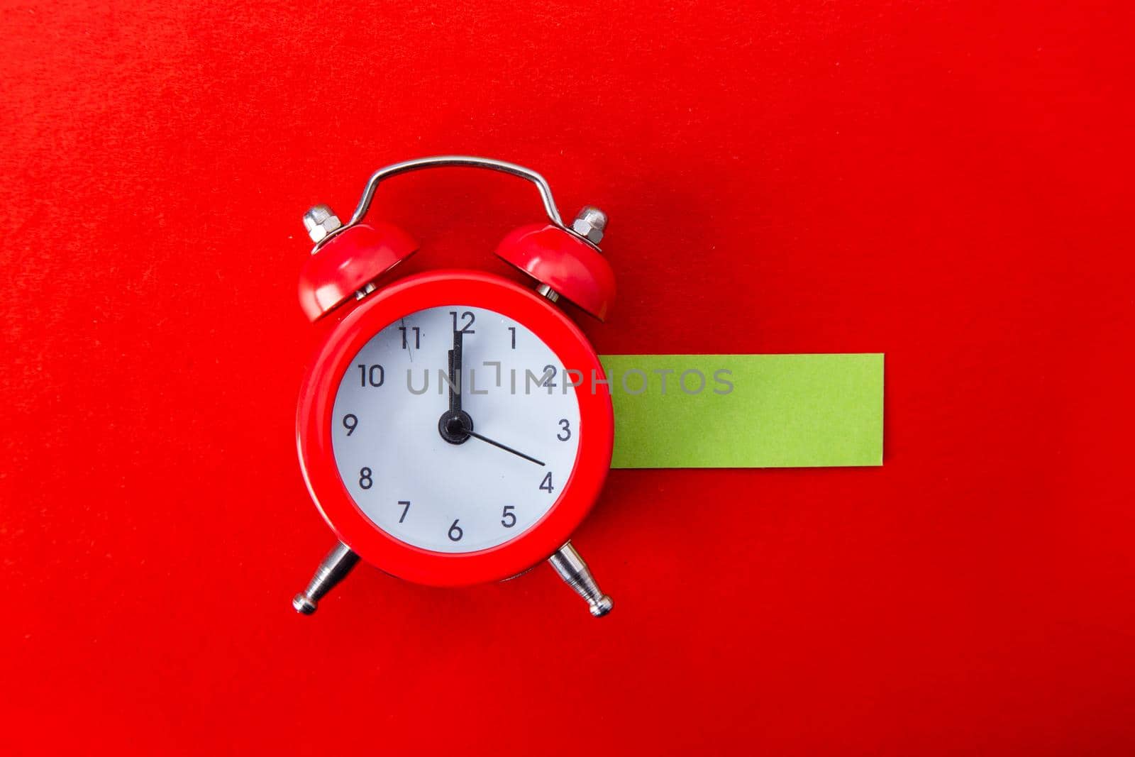 Alarm clock on red background. Copy Space