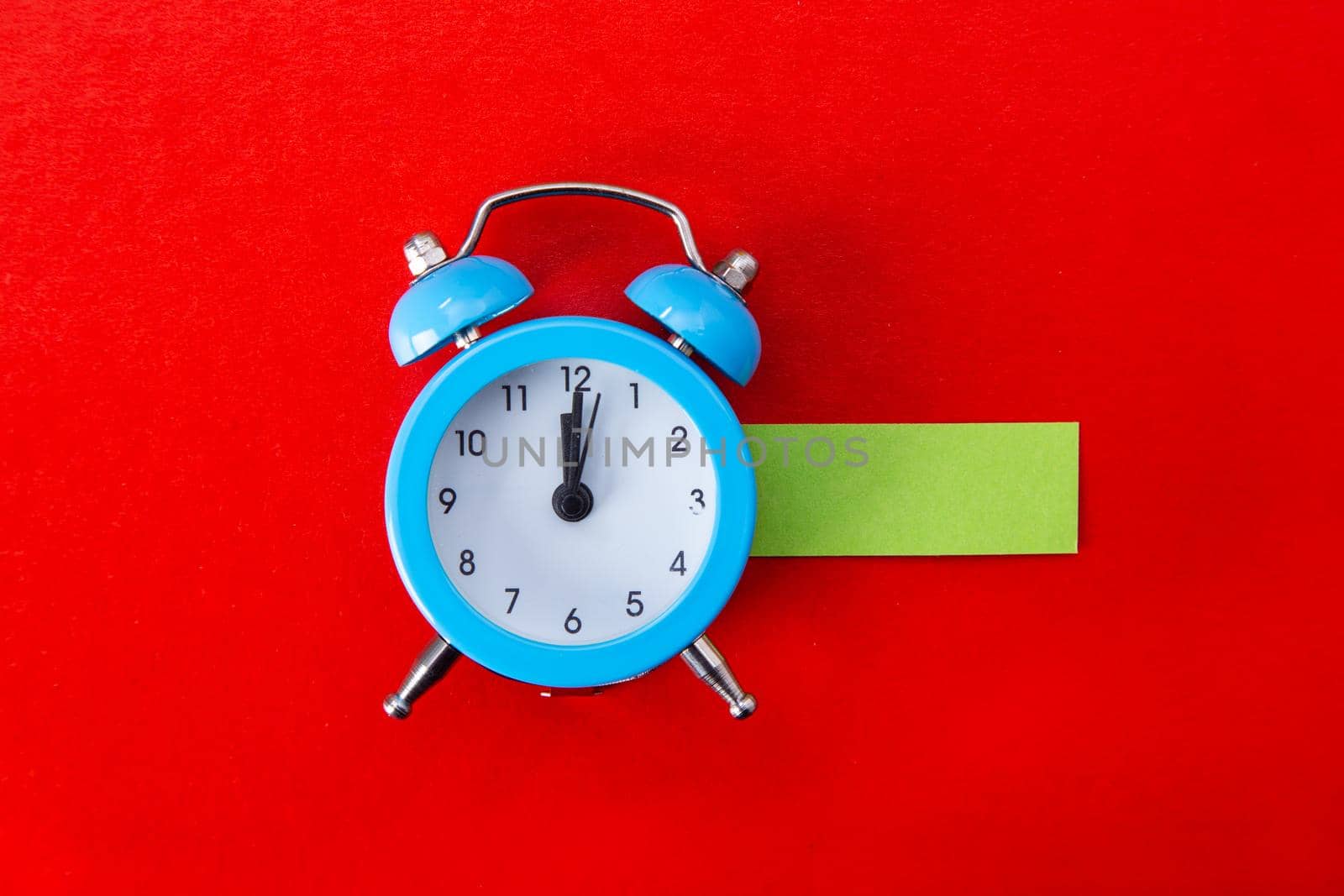 Alarm clock on red background. Copy Space