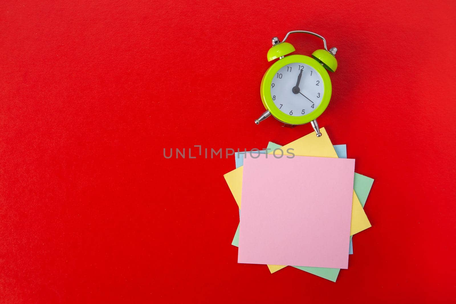 Alarm clock on red background. Copy Space