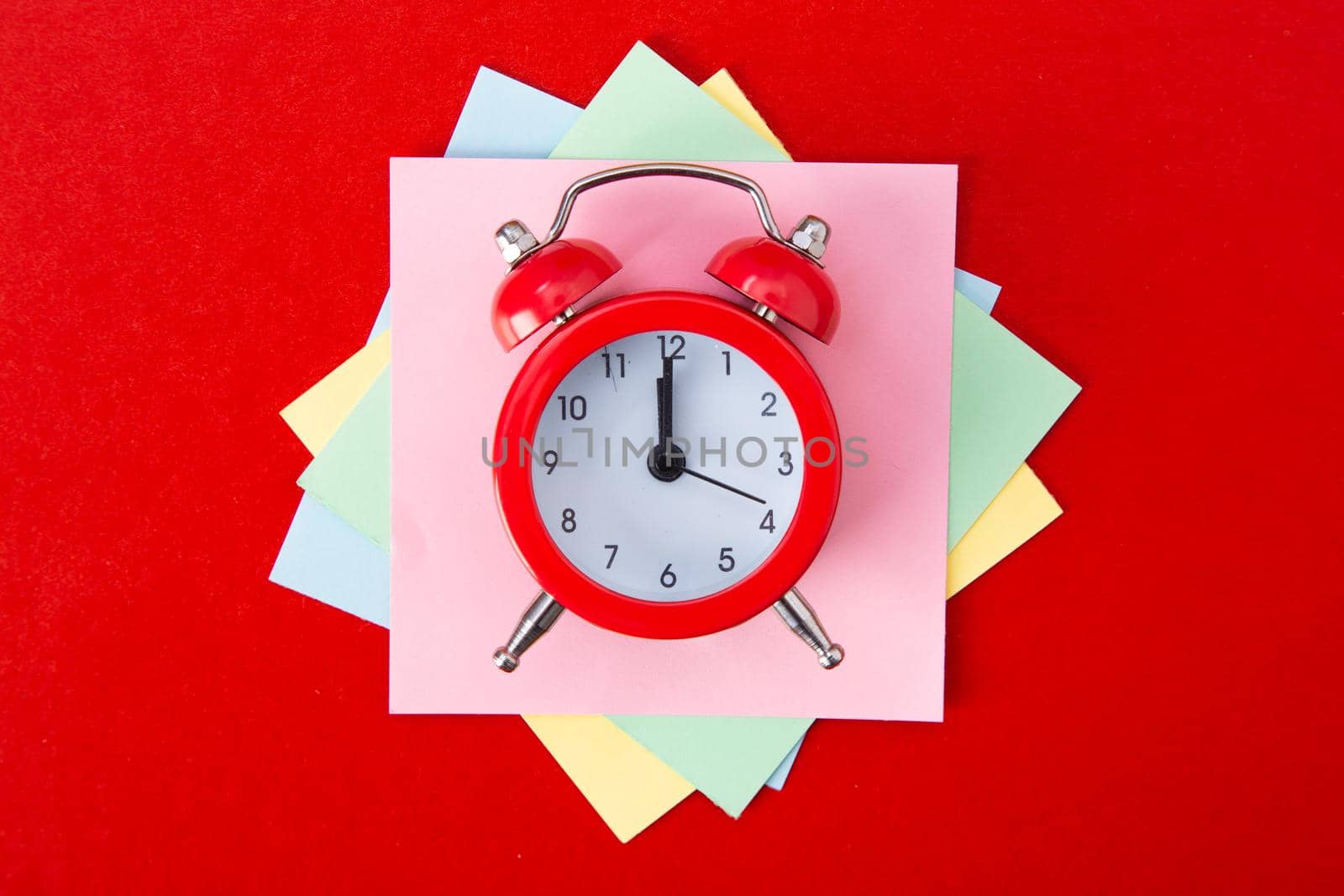Alarm clock on red background. Copy Space