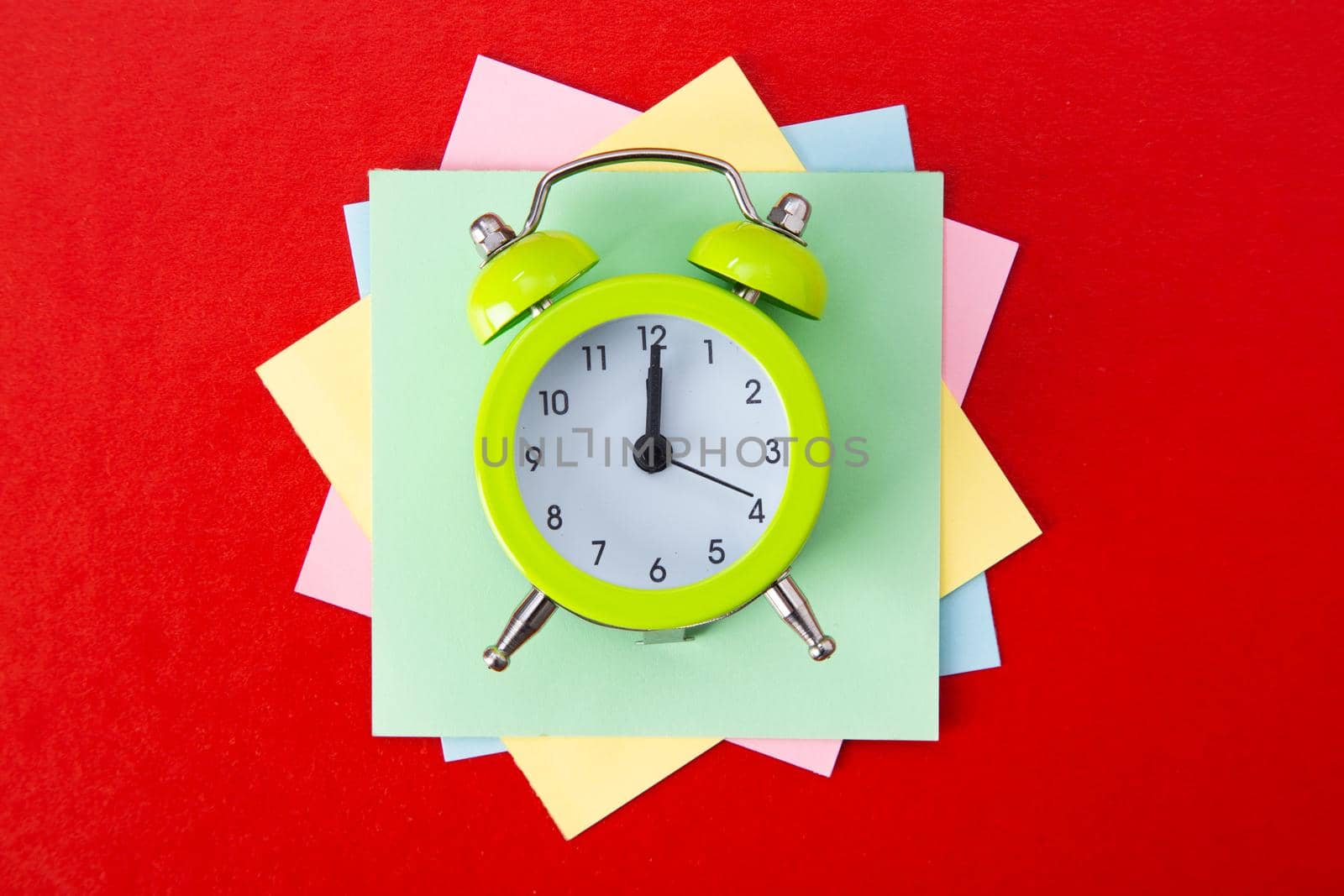 Alarm clock on red background. Copy Space