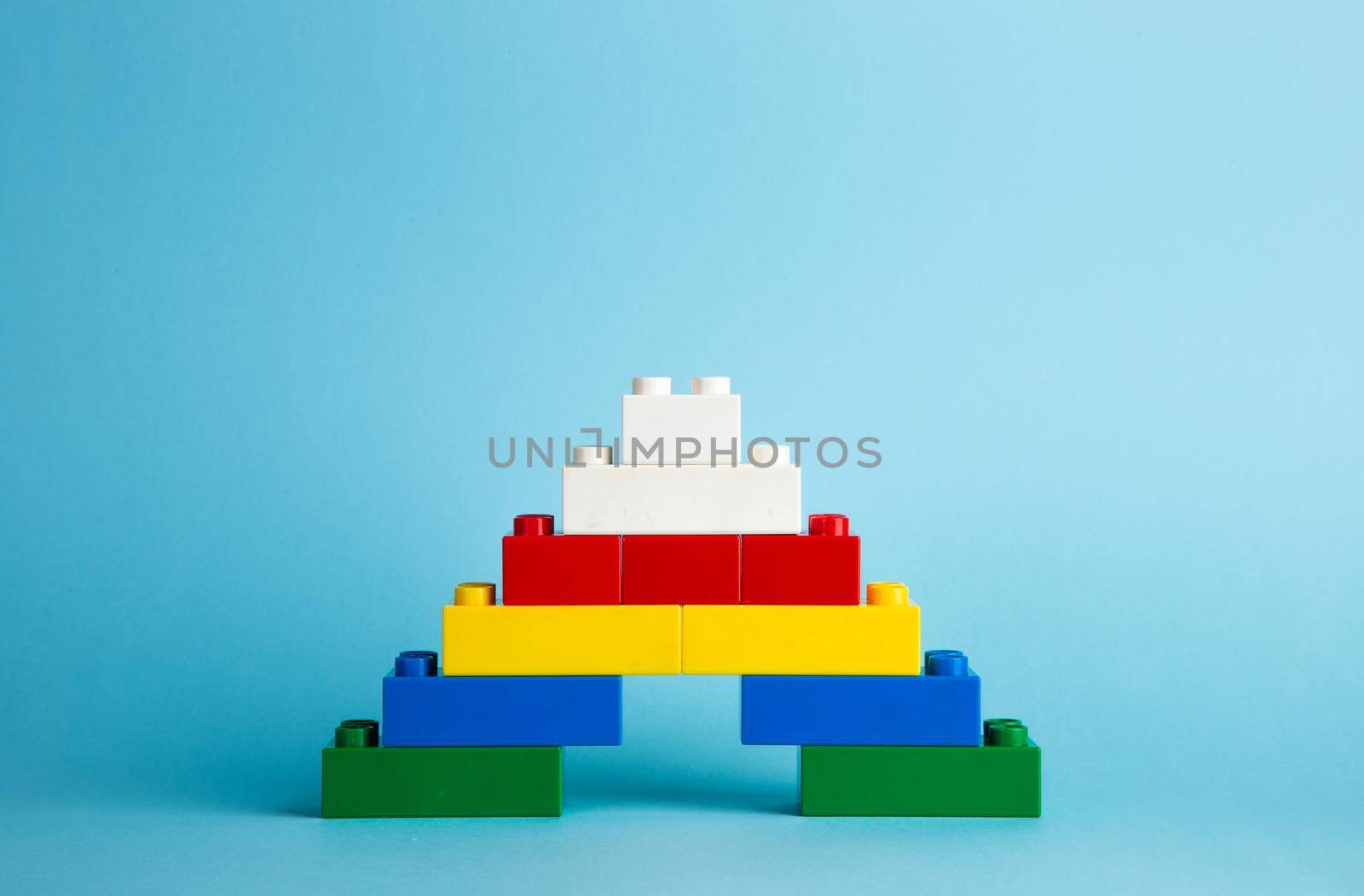 Plastic building blocks on red background