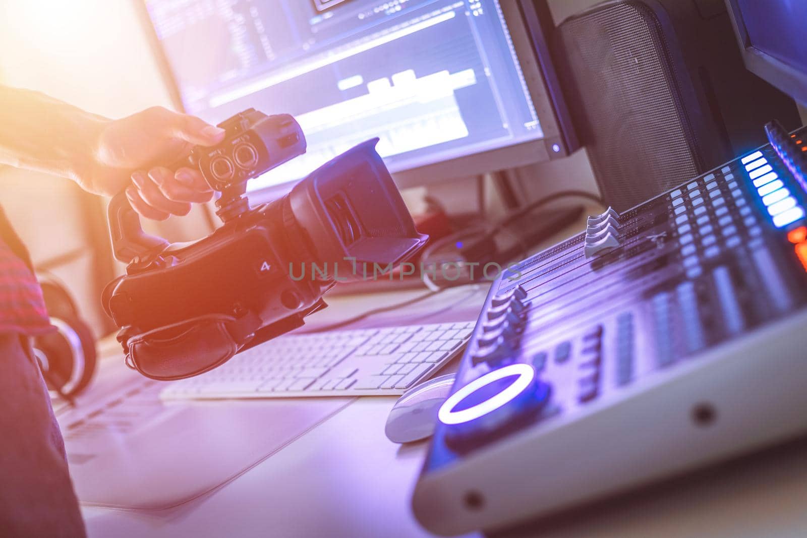 Video editing, recording and cutting room with monitors, camera and sound mixing desk