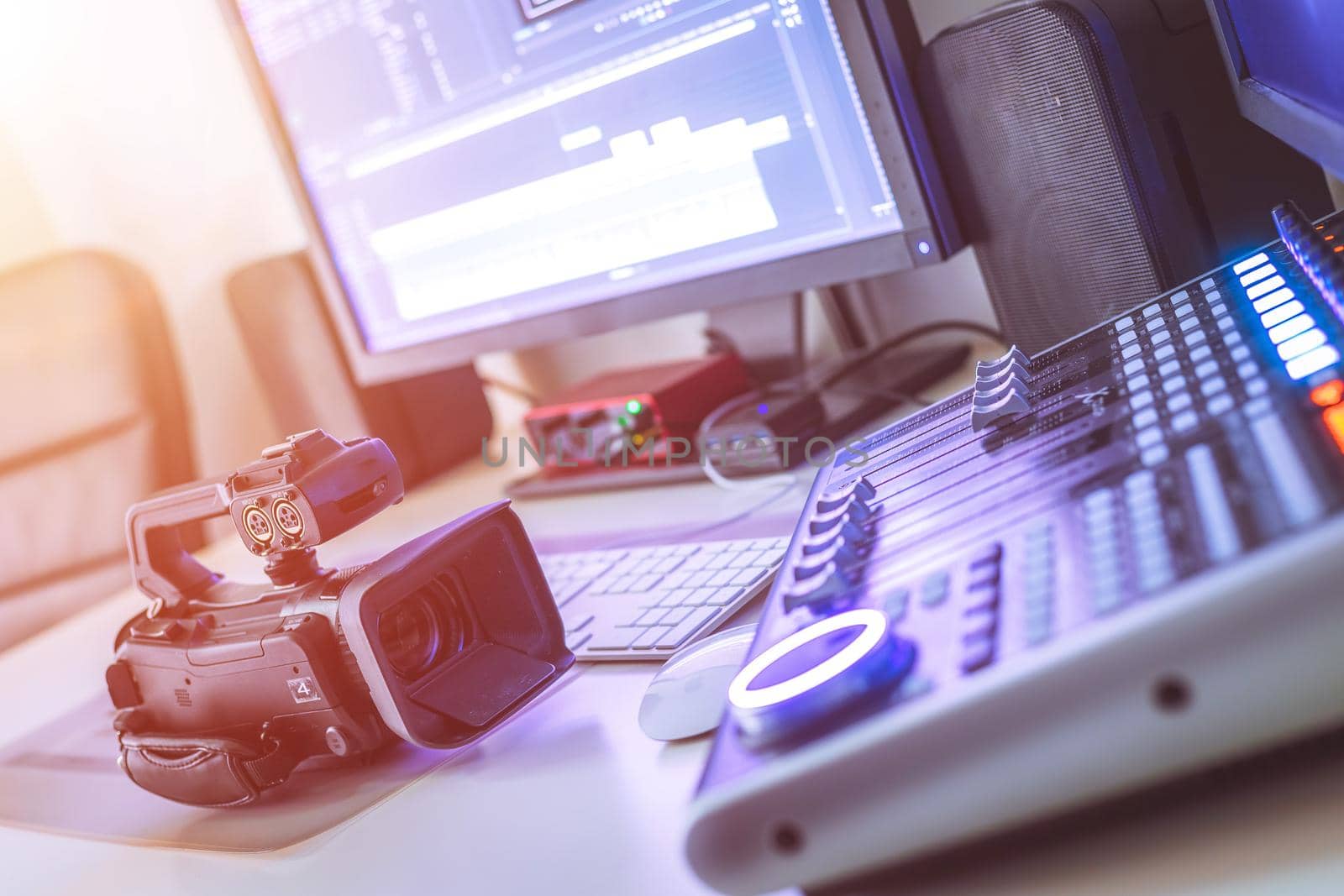 Video editing, recording and cutting room with monitors, camera and sound mixing desk