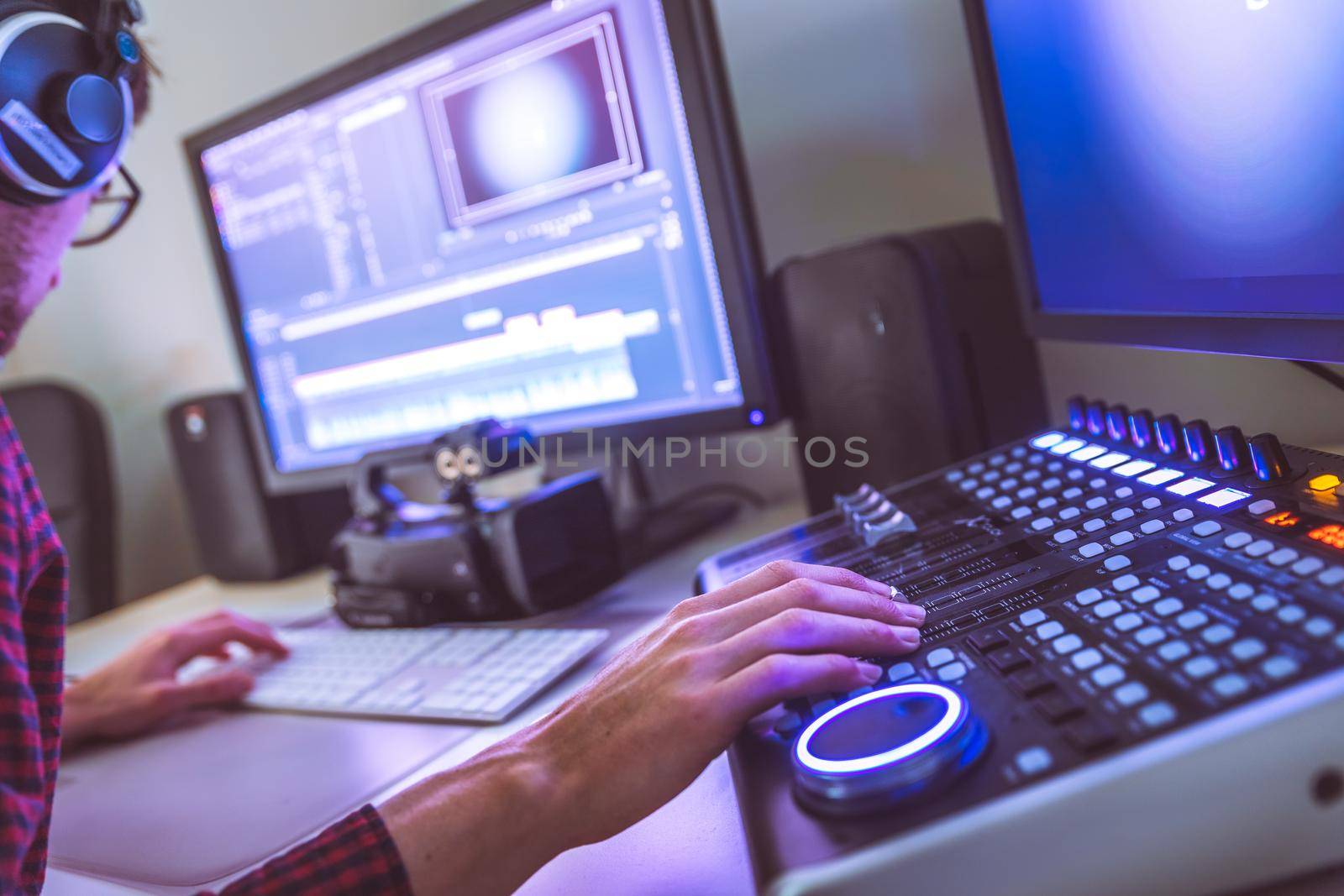 Video editing, recording and cutting room with monitors and sound mixing desk