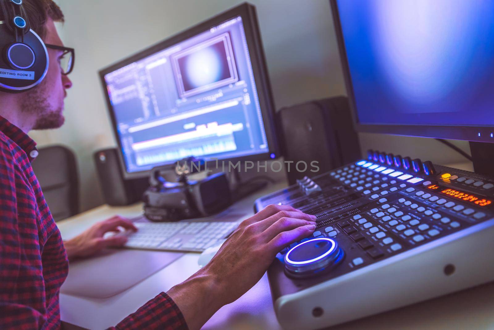 Video editing, recording and cutting room with monitors and sound mixing desk