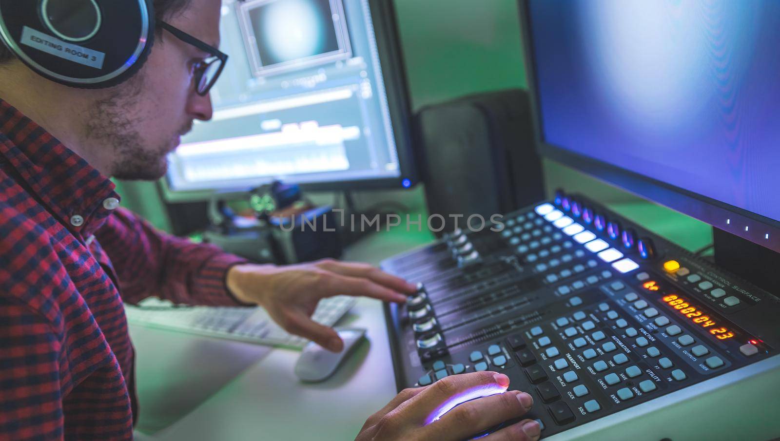 Video editing, recording and cutting room with monitors and sound mixing desk