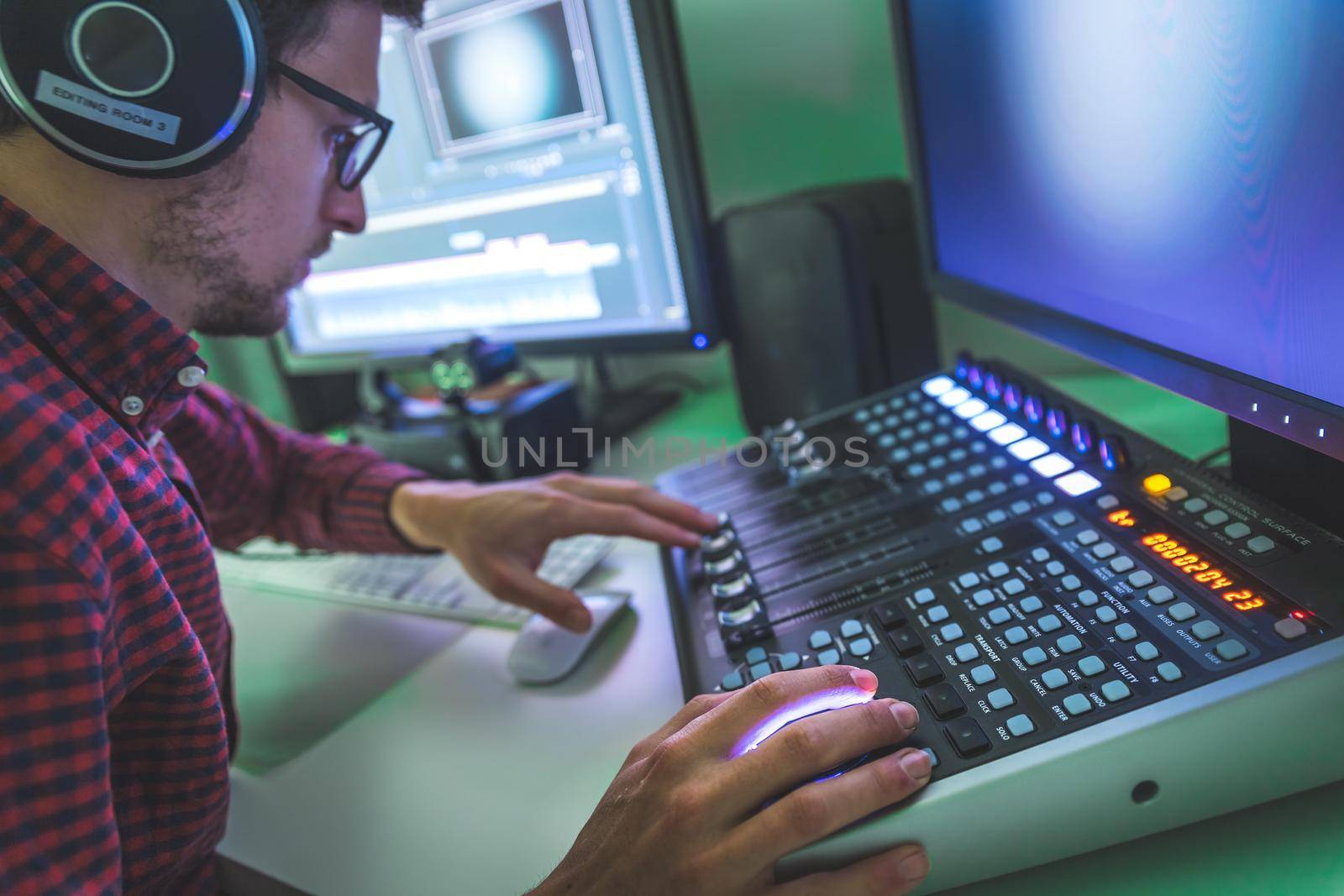 Video editing, recording and cutting room with monitors and sound mixing desk