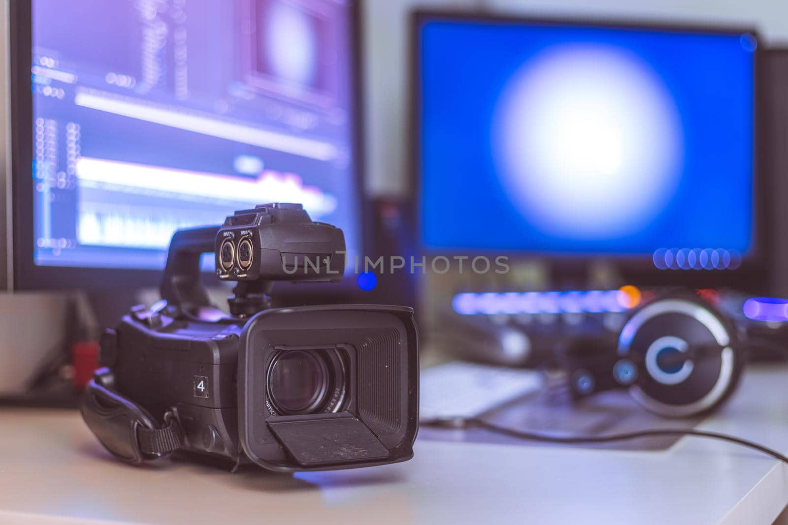 Video editing, recording and cutting room with monitors, camera and sound mixing desk