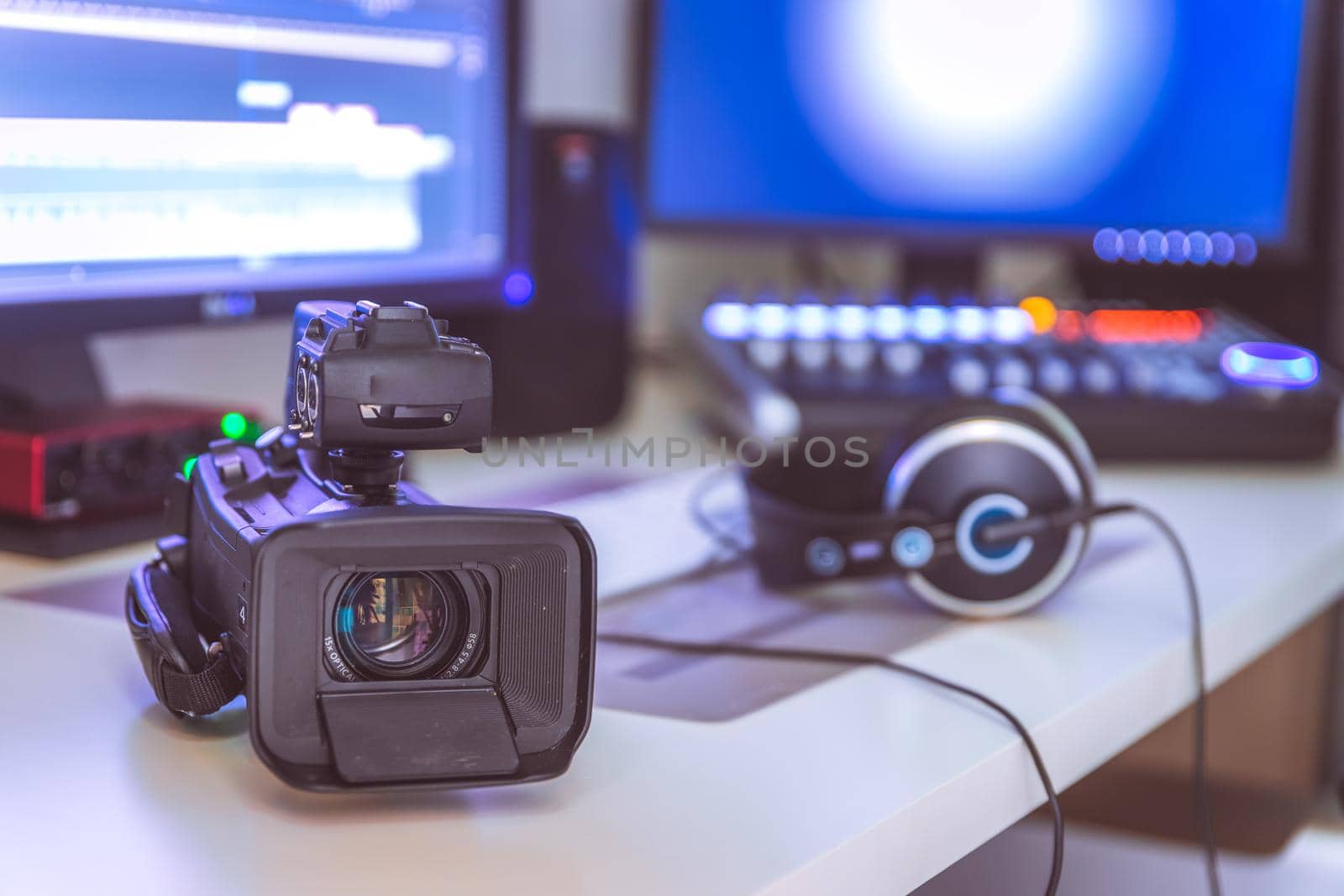Video editing, recording and cutting room with monitors, camera and sound mixing desk