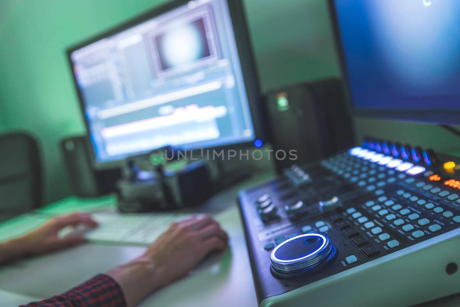 Video editing, recording and cutting room with monitors and sound mixing desk