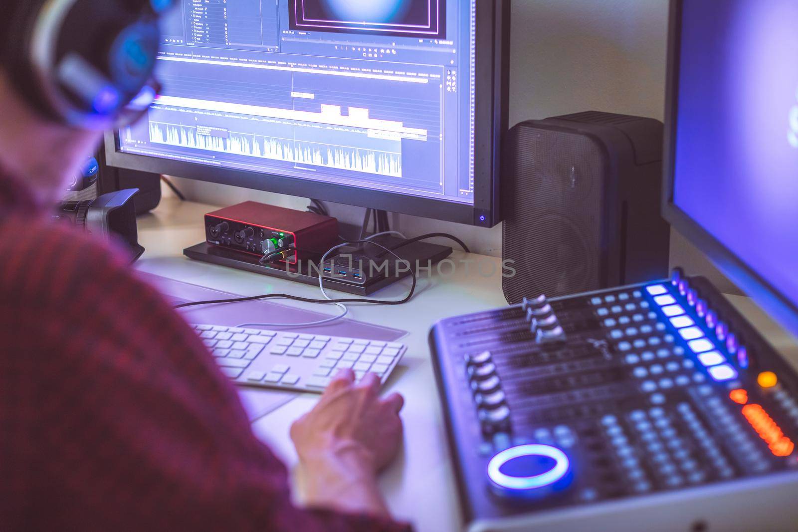 Video editing, recording and cutting room with monitors and sound mixing desk