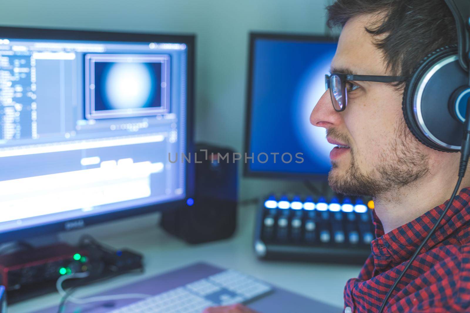 Video editing, recording and cutting room with monitors and sound mixing desk