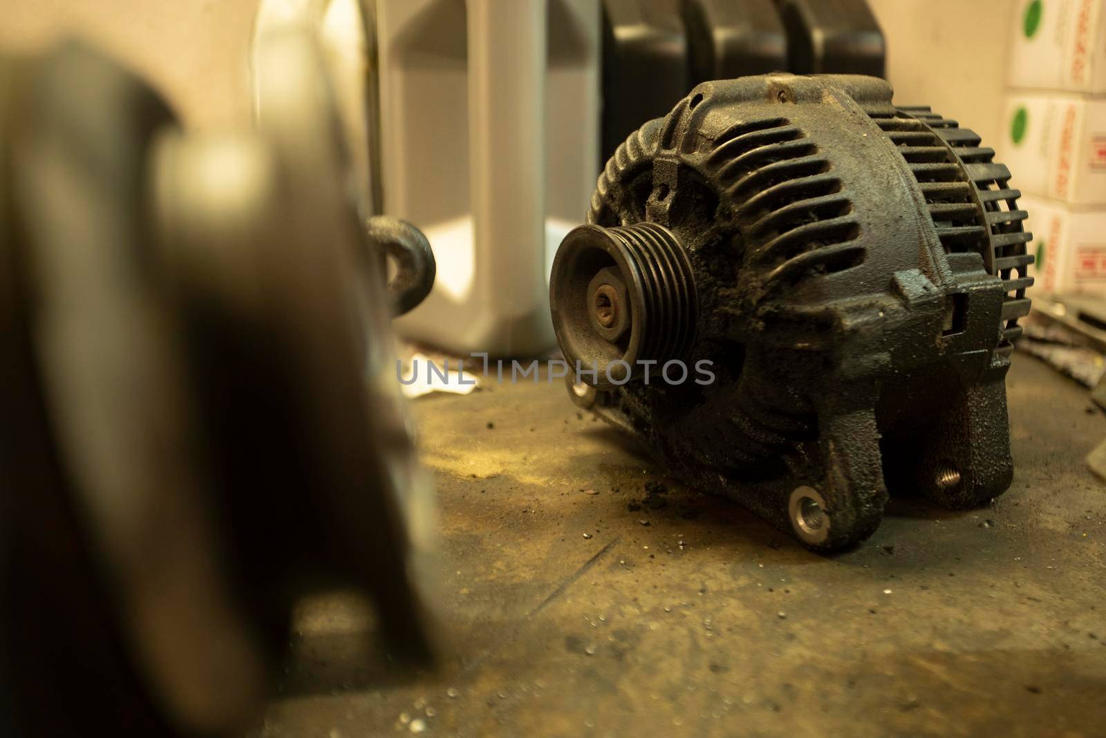 Old worn alternator of the car to be replaced