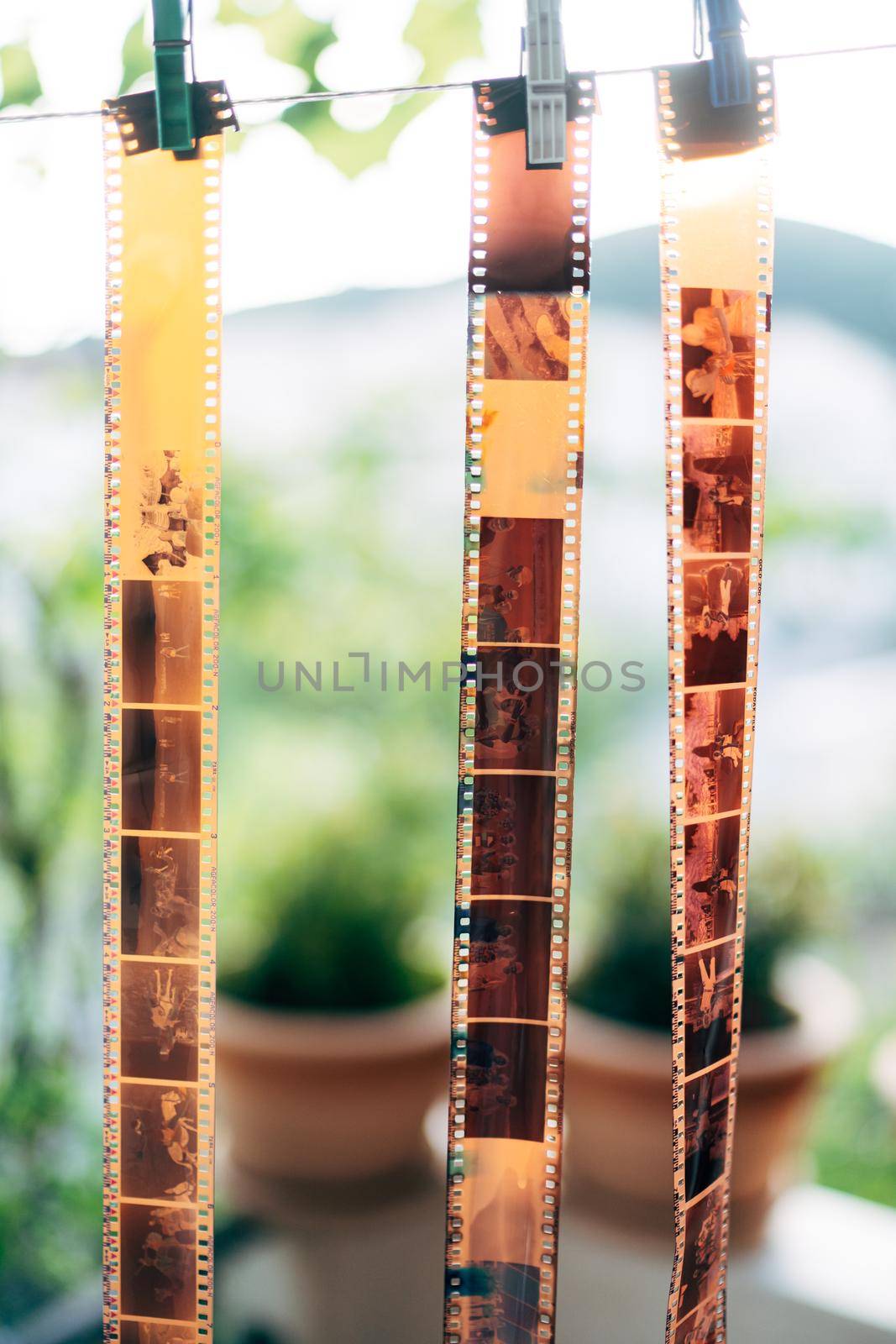 Old photographic film rolls, cassettes and retro cameras on the background. Old 35 mm negative film strip. High quality photo