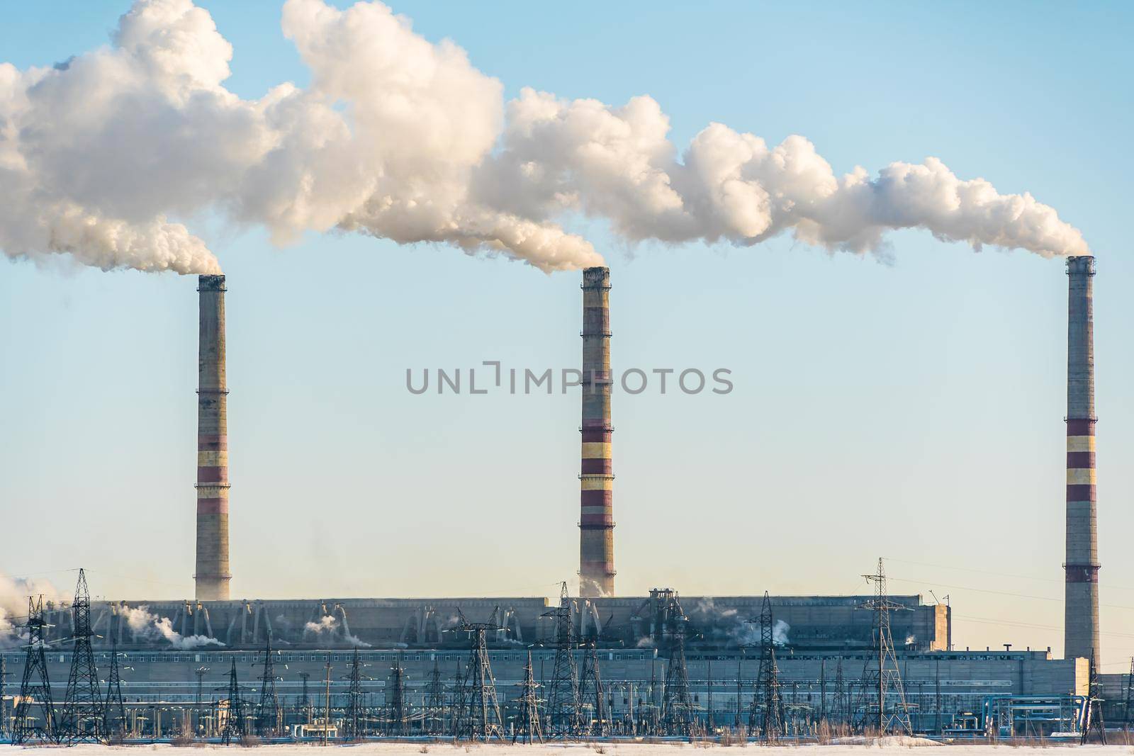 Smoking factory chimneys.Environmental problem of pollution of environment and air in large cities.Climate change,ecology and global warming.The sky is smoky with toxic substances.Soot from factories by YevgeniySam