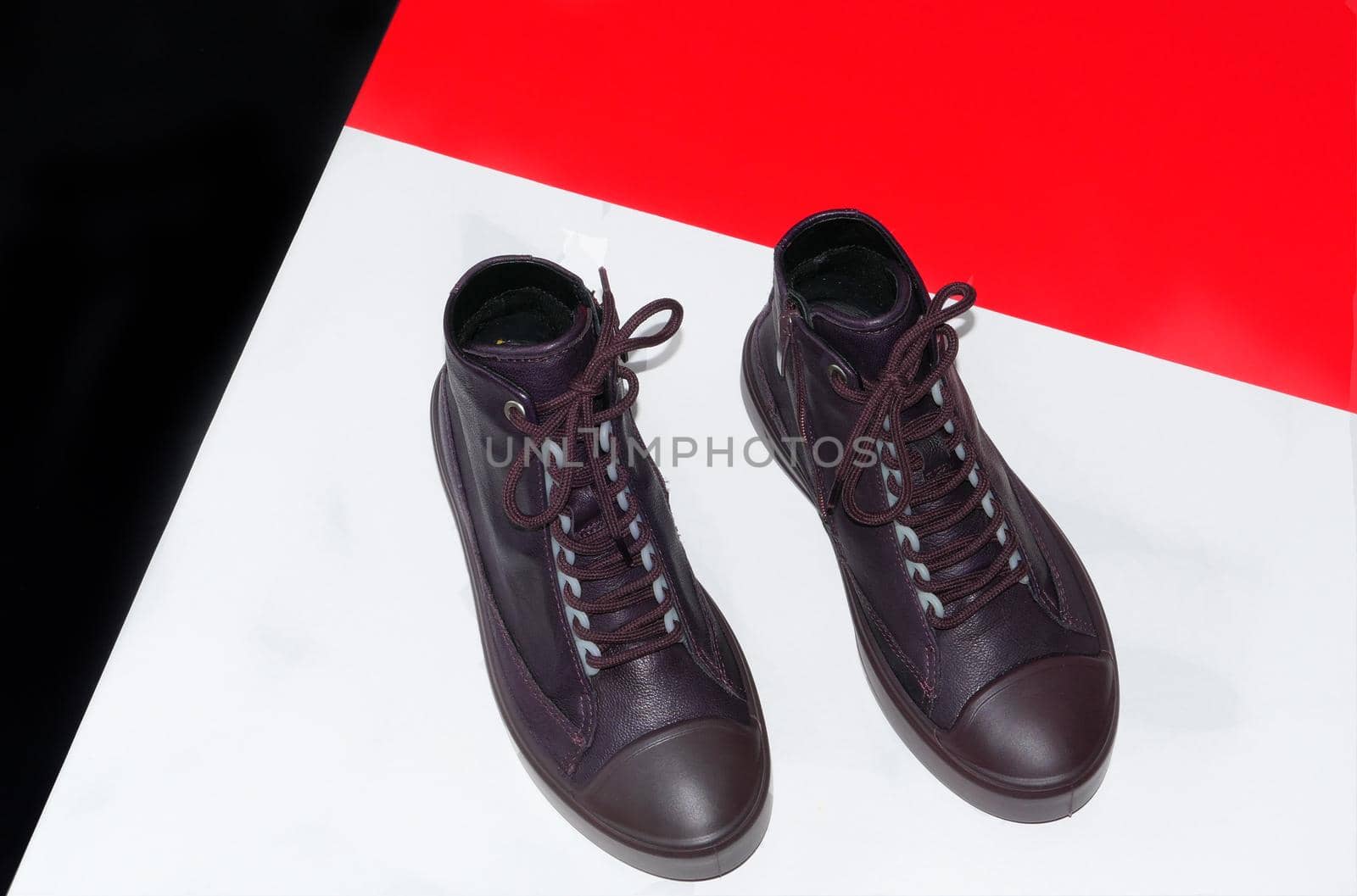 Stylish women's or children's shoes are brown leather, insulated against a colored background. High quality photo