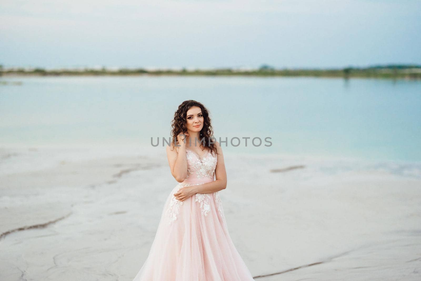 girl in a pink dress are walking along the white sand of the desert