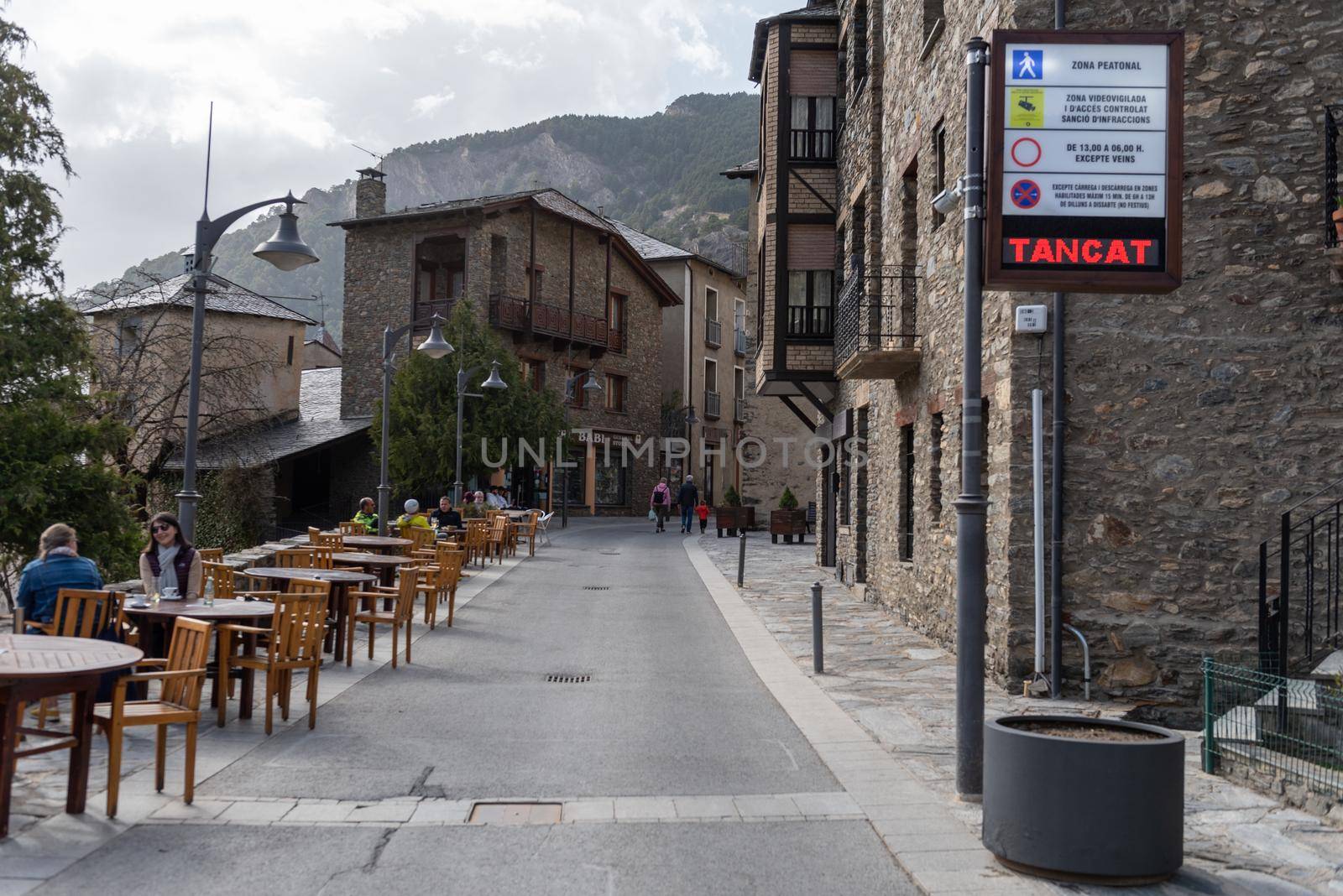 People walking down the street in spring in Ordino, Andorra in the Pyrenees in 2021. by martinscphoto