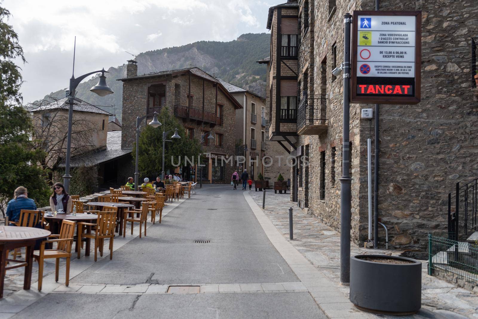 Ordino, Andorra: 2021 March 30: People walking down the street in spring in Ordino, Andorra in the Pyrenees in 2021.