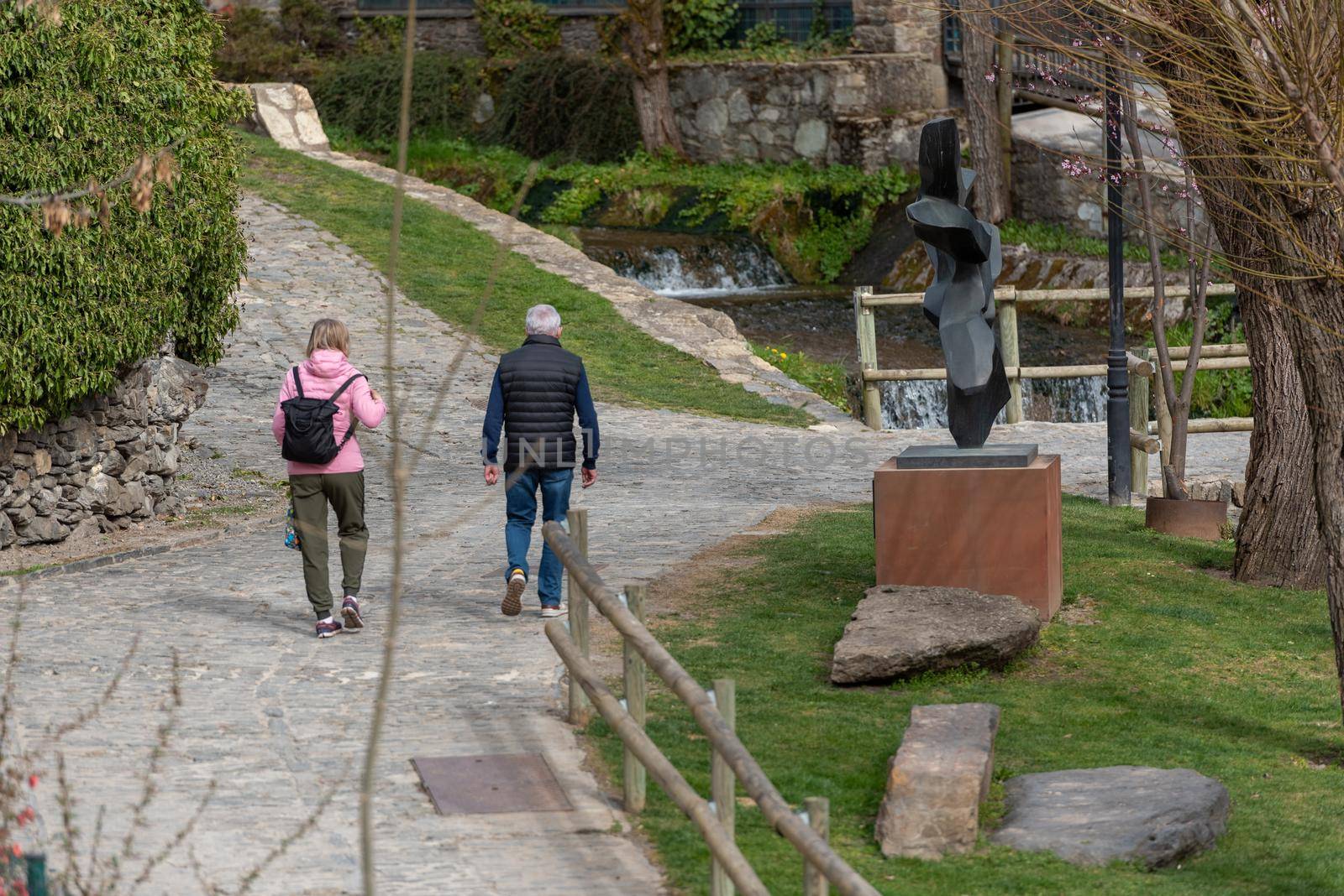 People walking down the street in spring in Ordino, Andorra in the Pyrenees in 2021. by martinscphoto