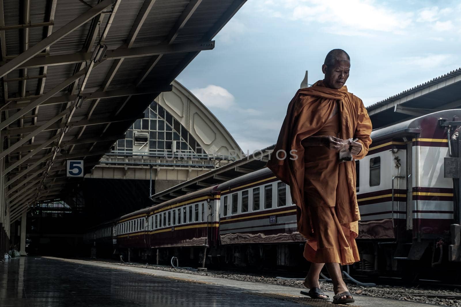 Bangkok, thailand - Jul 7, 2019 : A Monk Walking In Hua Lamphong Railway Station With Train And Railway Background.